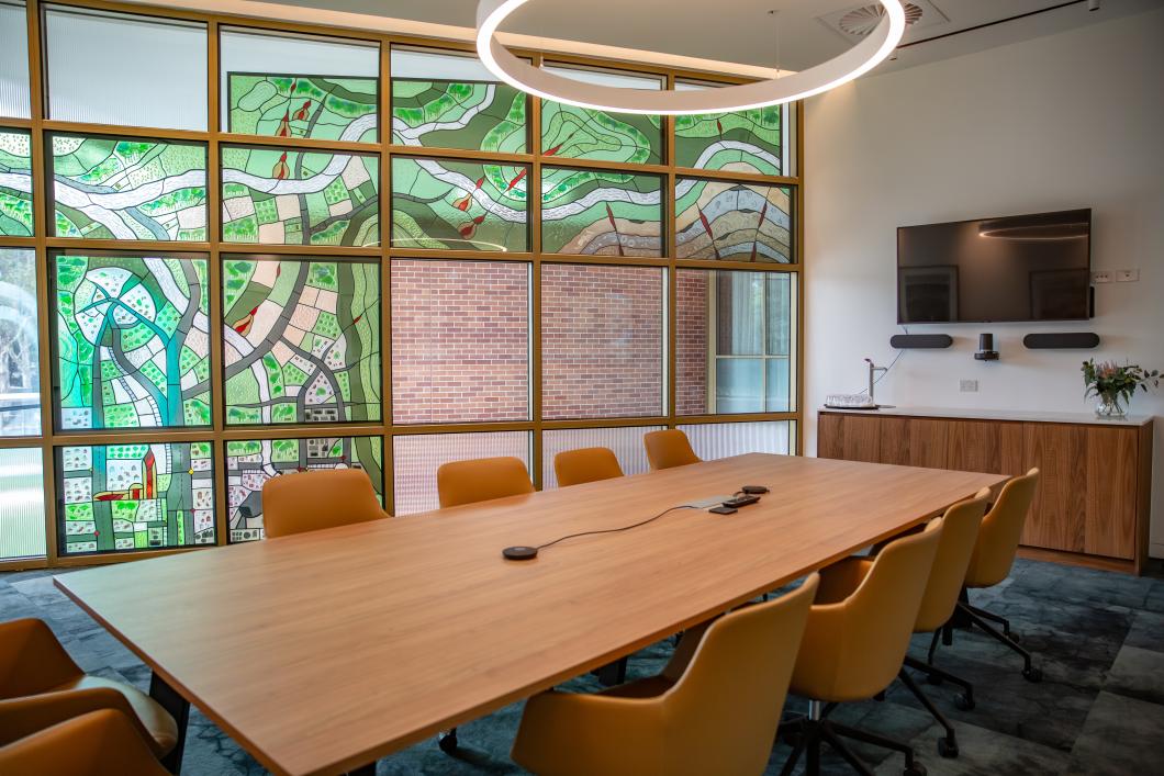 leadlit filled room with boardroom table and chairs