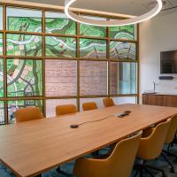 leadlit filled room with boardroom table and chairs