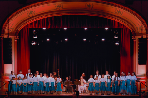 A choir sings on a stage